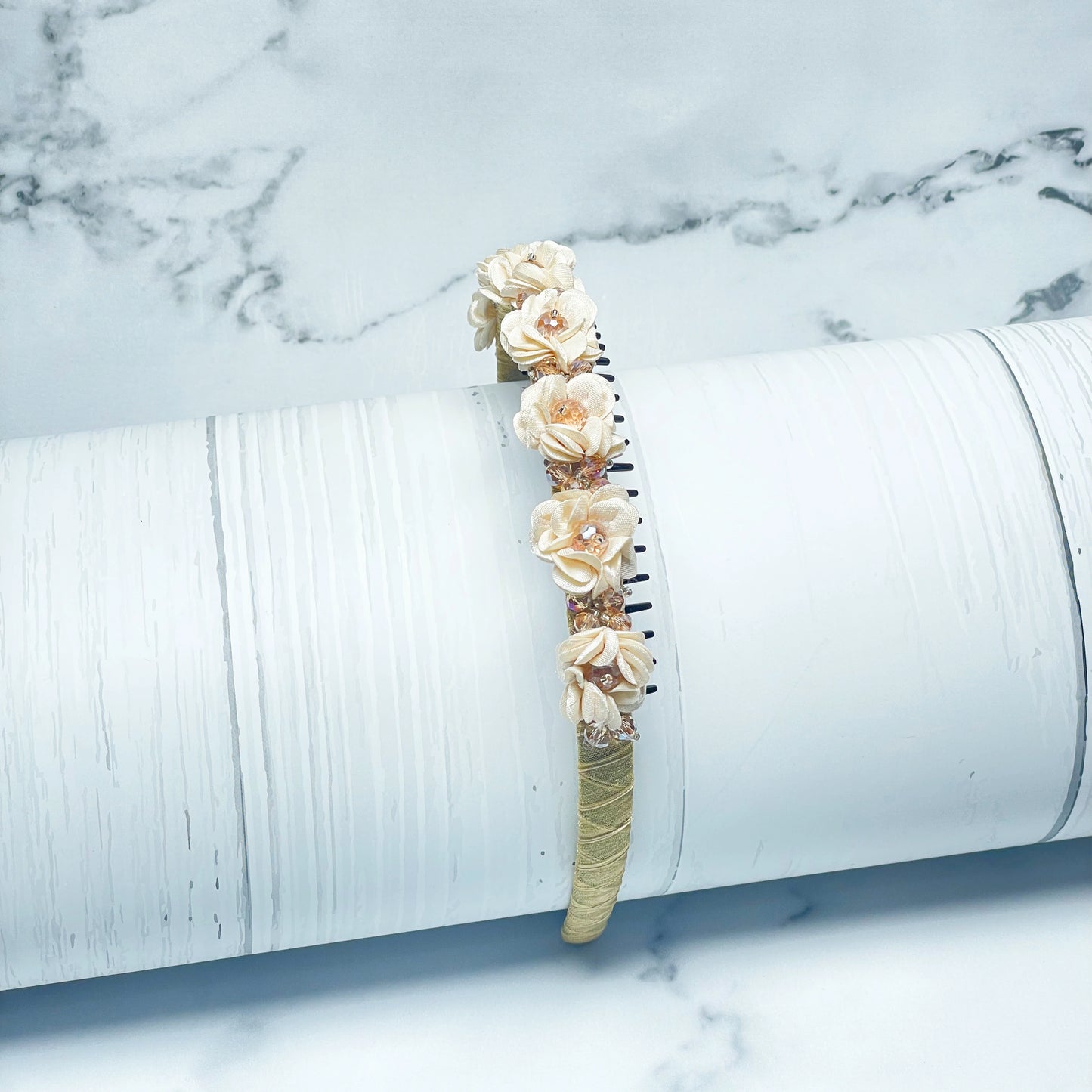 Cream floral hairband decorated with crystals on a white textured background Crystal Studded Floral Hairbands