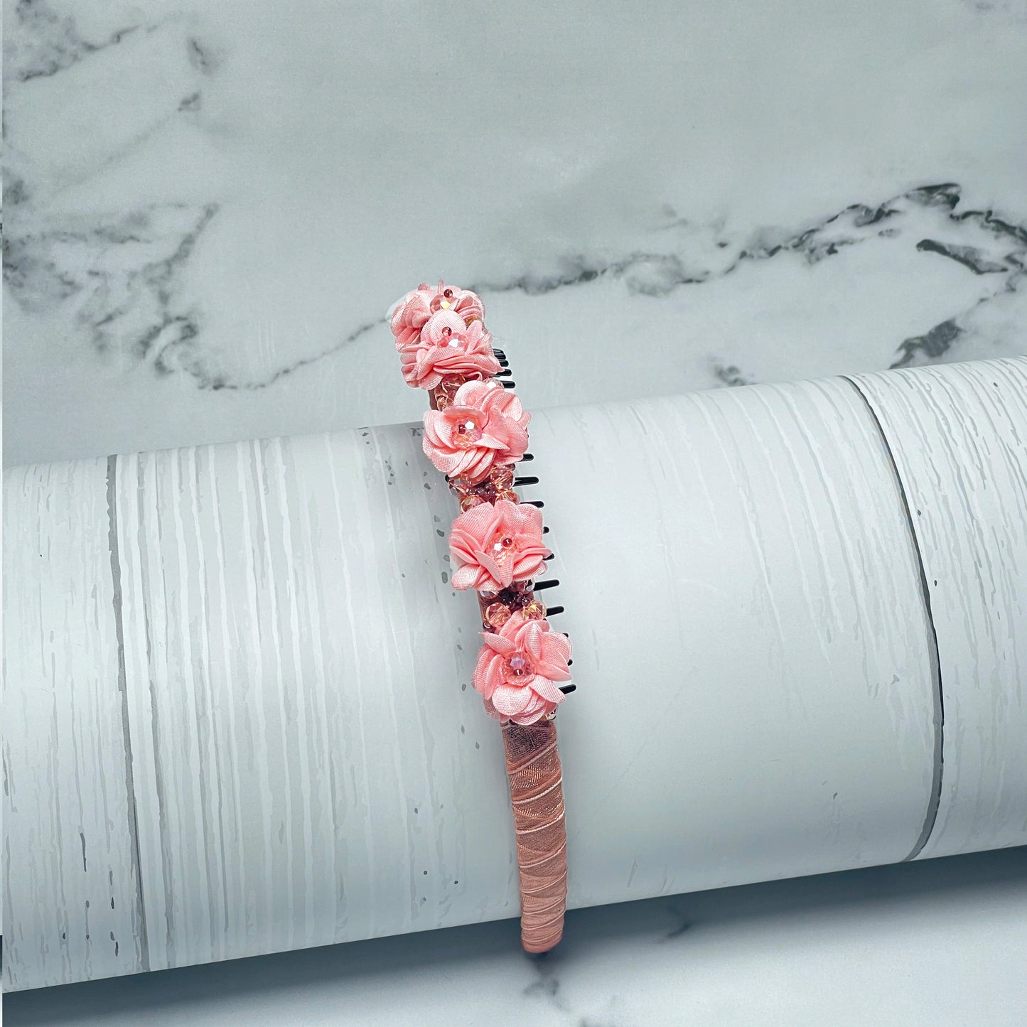 Pink Crystal Studded Floral Hairbands with delicate flower decorations on a textured background