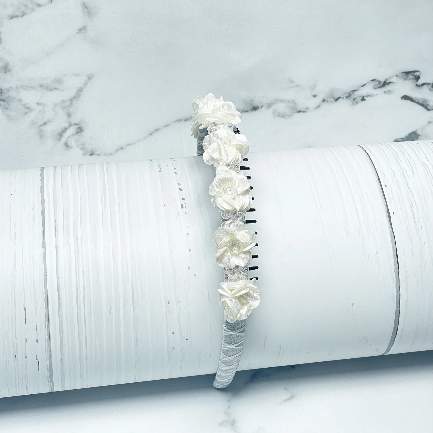 Crystal Studded Floral Hairbands featuring white fabric flowers on a wrapped band