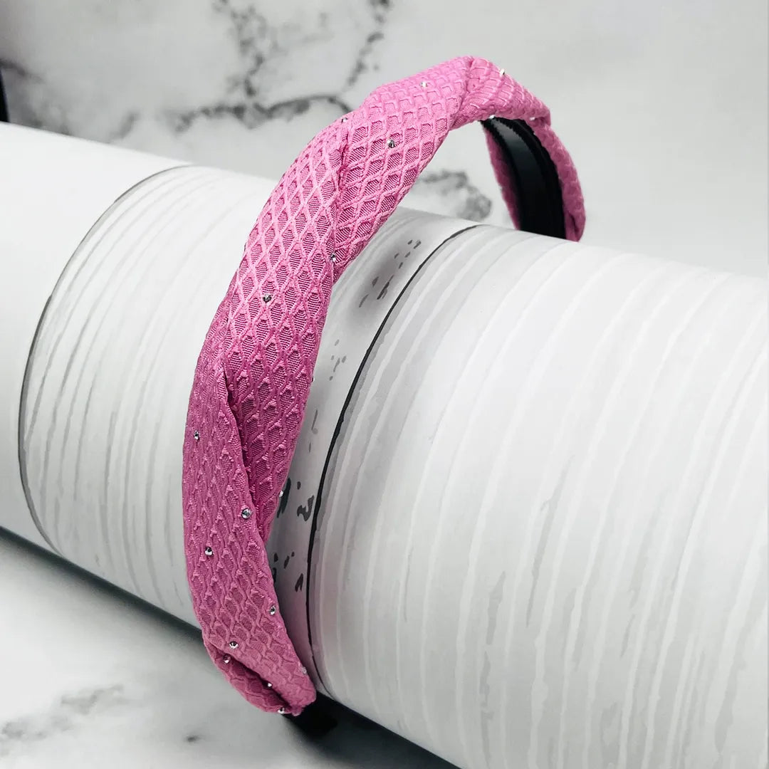 Pink Light Studded Hairbands with textured fabric and small sparkling studs displayed on a white cylindrical prop