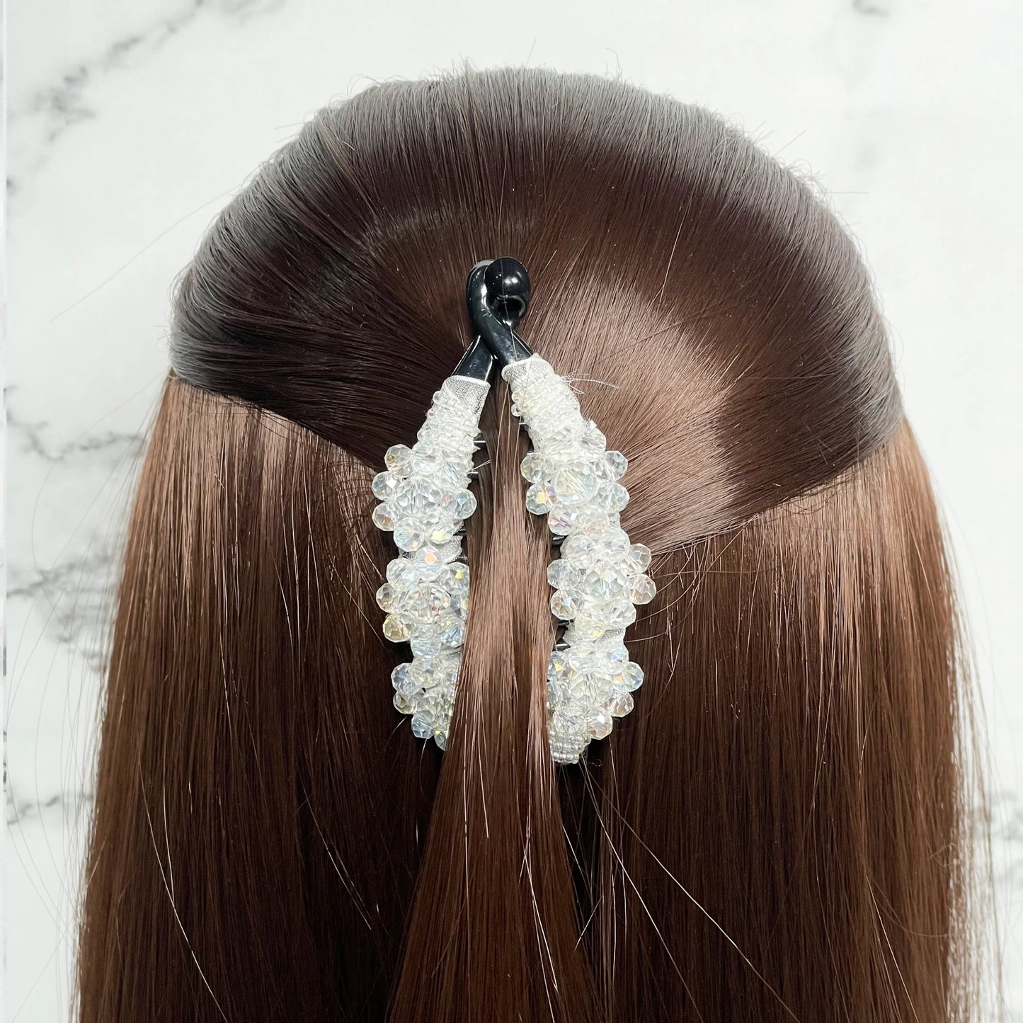 Bella Luxe white crystal studded banana clip securing half-up hairstyle on brown hair