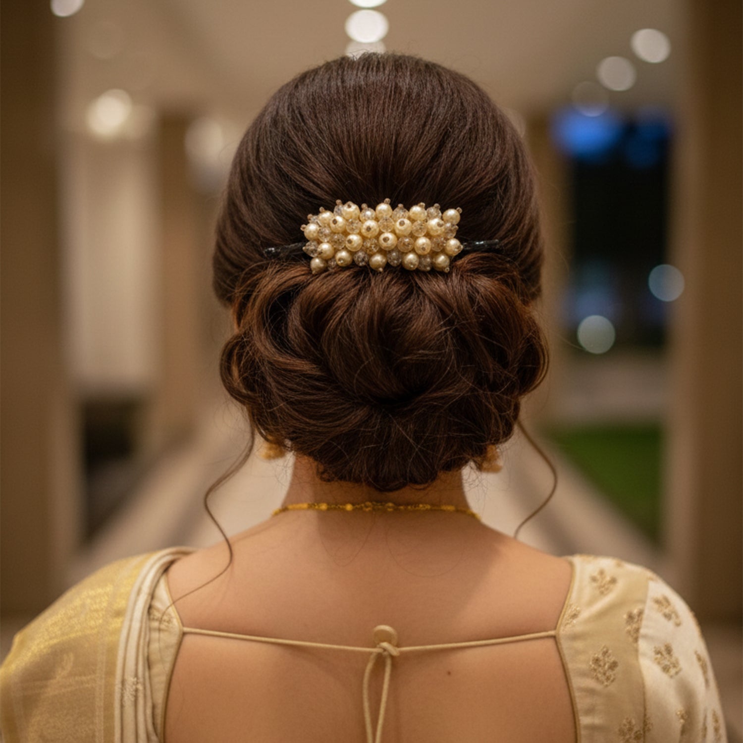 Three decorative white bow hair pins placed on dark brown hair against a marble background