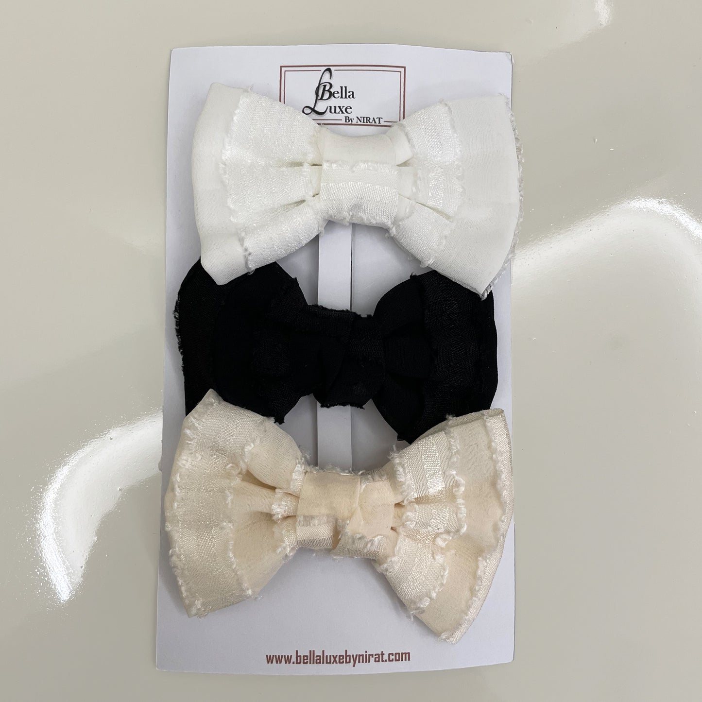 Bella Luxe trendy georgette bow clips set with white black and beige bows on display card