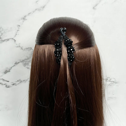 Bella Luxe black crystal studded banana clip securing half-up hairstyle on long brown hair