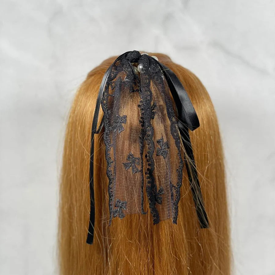 Black lacy pearl hair ties with delicate lace and ribbon details styled in red hair