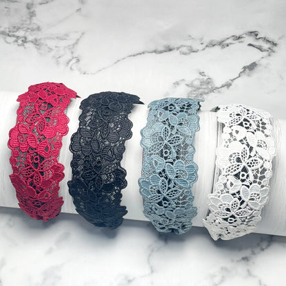 Set of broad lacy hairbands in red black gray and white with intricate floral lace patterns
