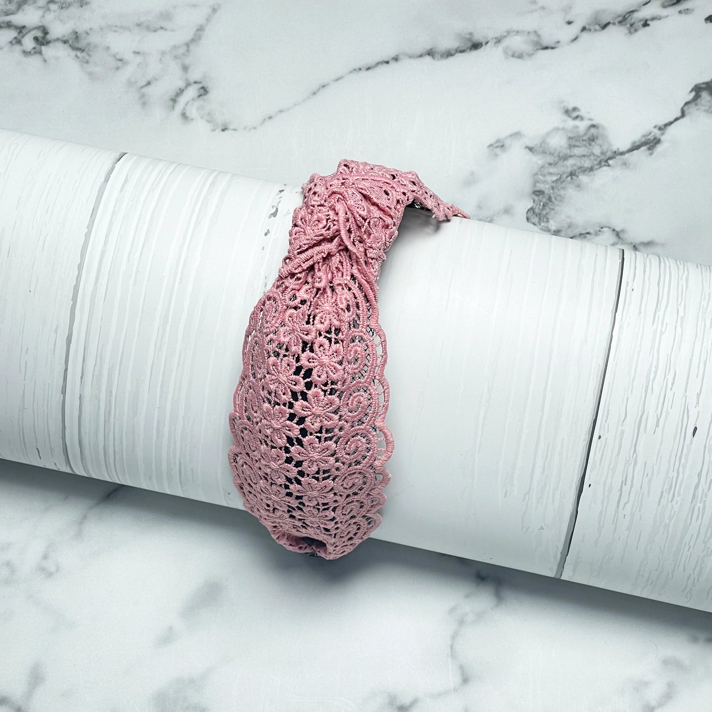 Pink Broad Lacy Knotted Hairbands with floral lace design on white textured display