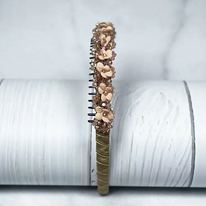 Brown embellished headbands for women with flower and bead decorations on a white background