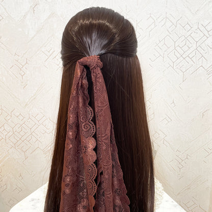 Brown lacy hair scarf tied to long straight hair with intricate lace pattern by Bella Luxe