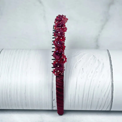 Red embellished headbands for women with floral and bead details on a fabric base