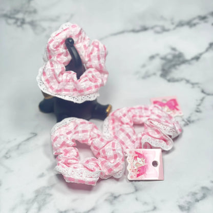 Pink and white check scrunchies with lace trim displayed on marble surface by mydevelopmentstor