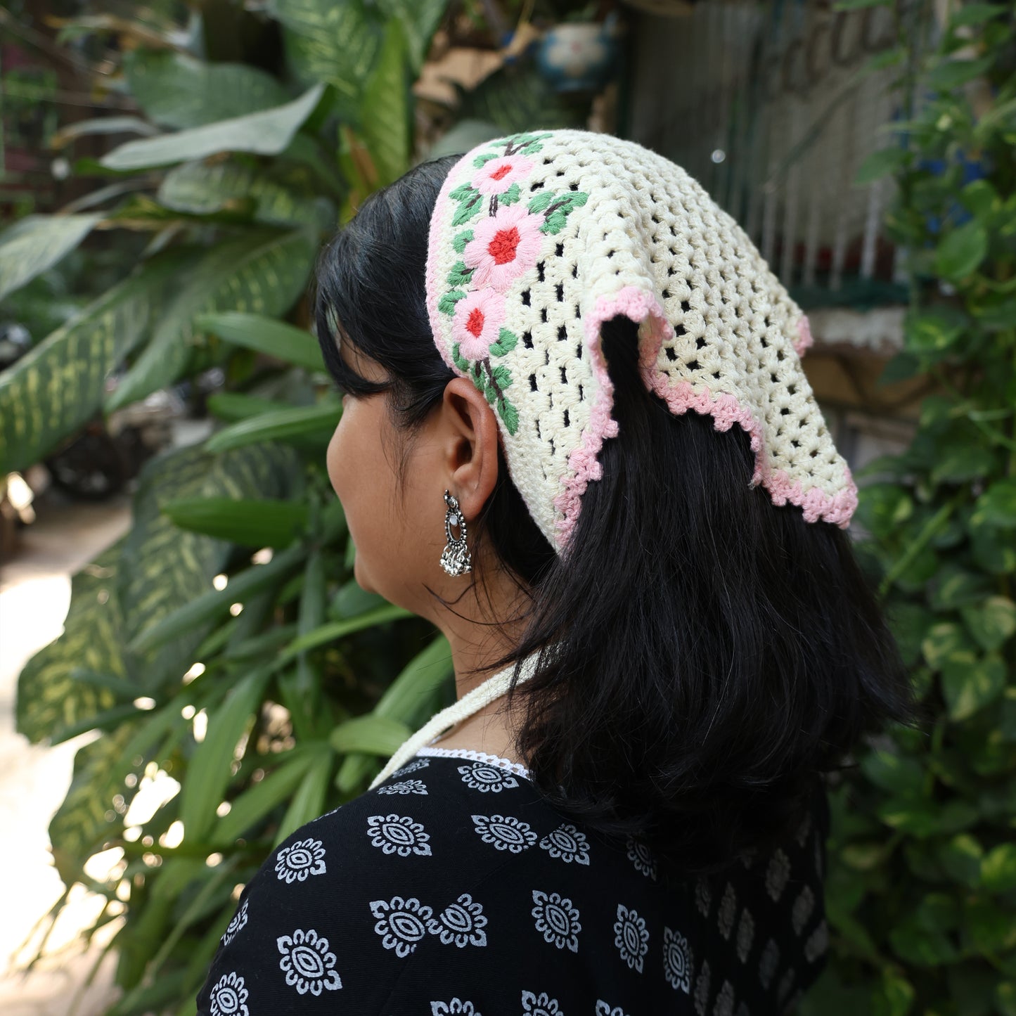 Cream Crochet Bandanas with Floral design worn by woman with black hair and earrings outdoors