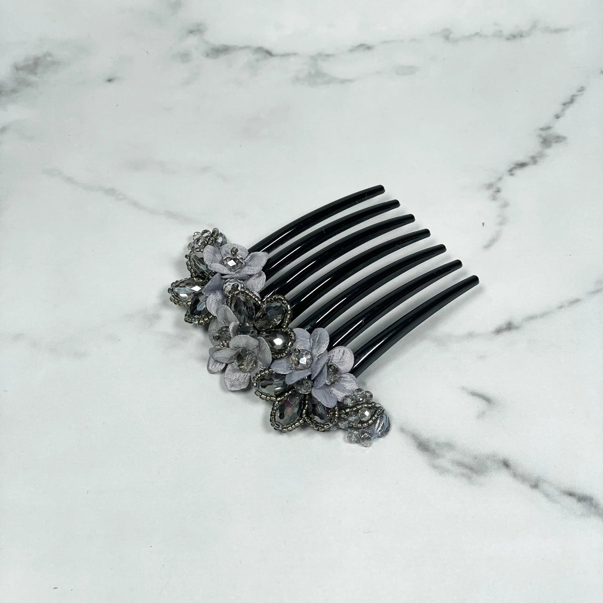 Black hair comb with delicate grey flowers and crystal studded comb clips embedded in decorative design