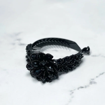 Black crystal studded hair bun clip with intricate flower design for stylish hair styling