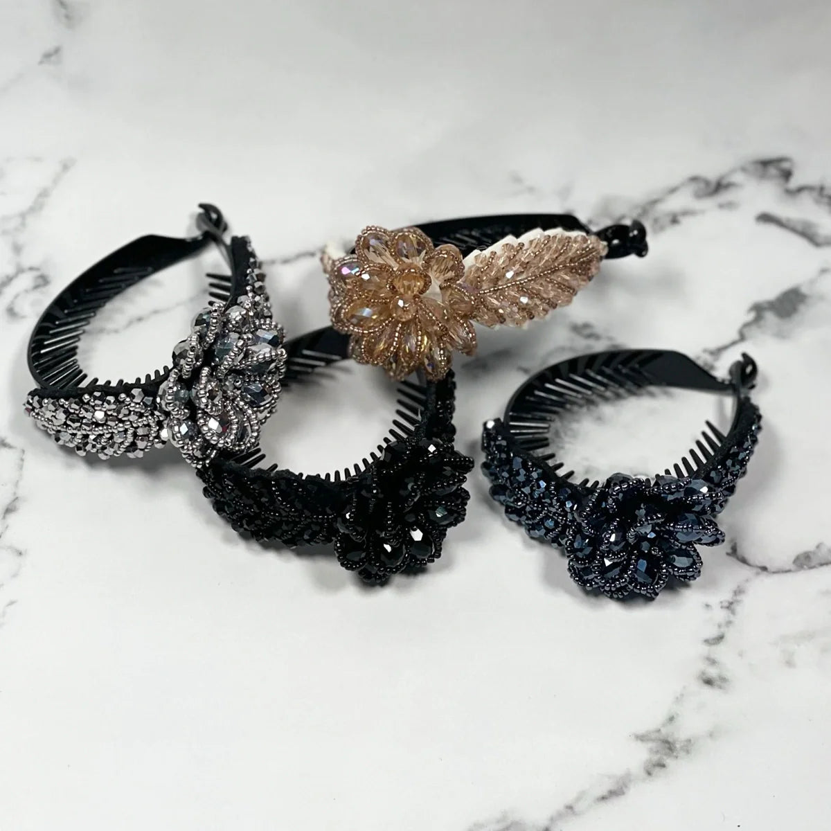 Crystal studded hair bun clip set featuring black and gold floral designs on comb bases