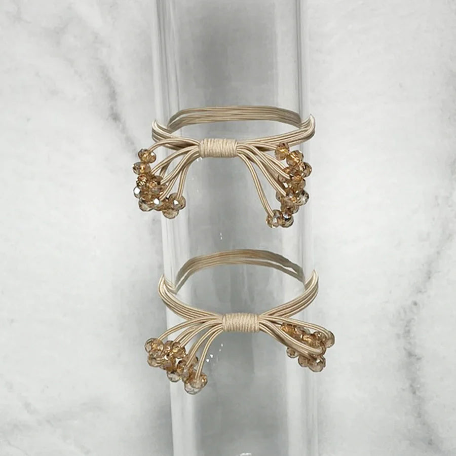 Crystal studded hair ties bow with gold elastic bands and sparkling beads in bow shape