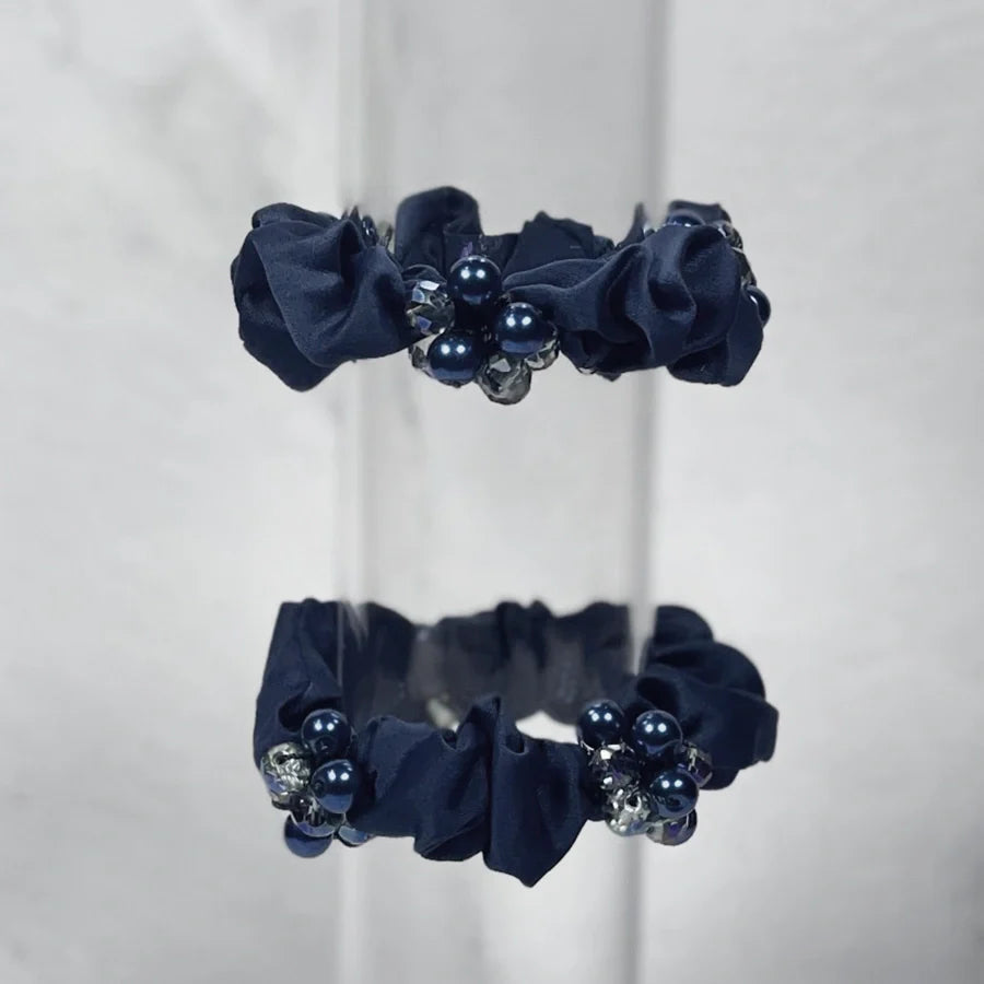 Set of black crystal studded hair ties with pearl and gem embellishments for stylish hair styling