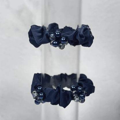 Set of black crystal studded hair ties with pearl and gem embellishments for stylish hair styling