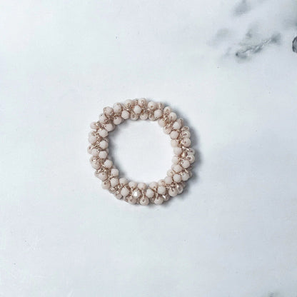 Beige crystal studded hair ties with small round beads arranged in a circular design