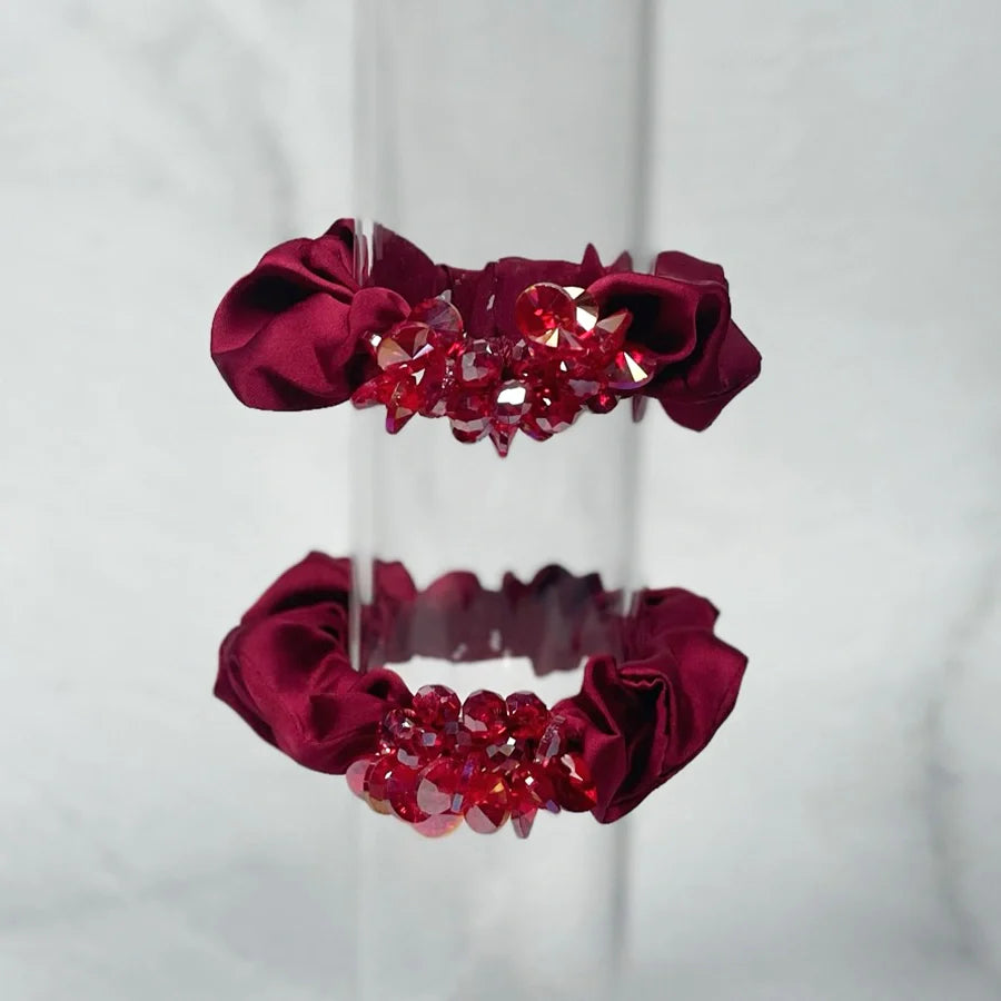 Burgundy crystal studded hair ties with sparkling red crystals on satin fabric bands