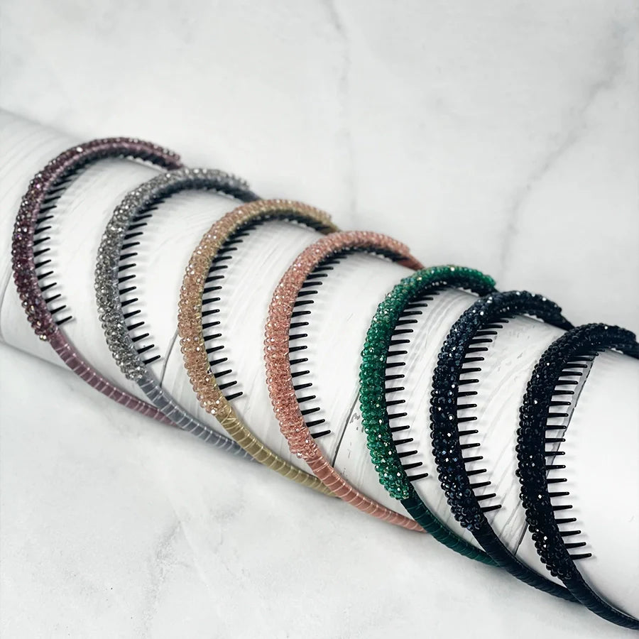Set of colorful crystal studded headbands for women displayed on white background