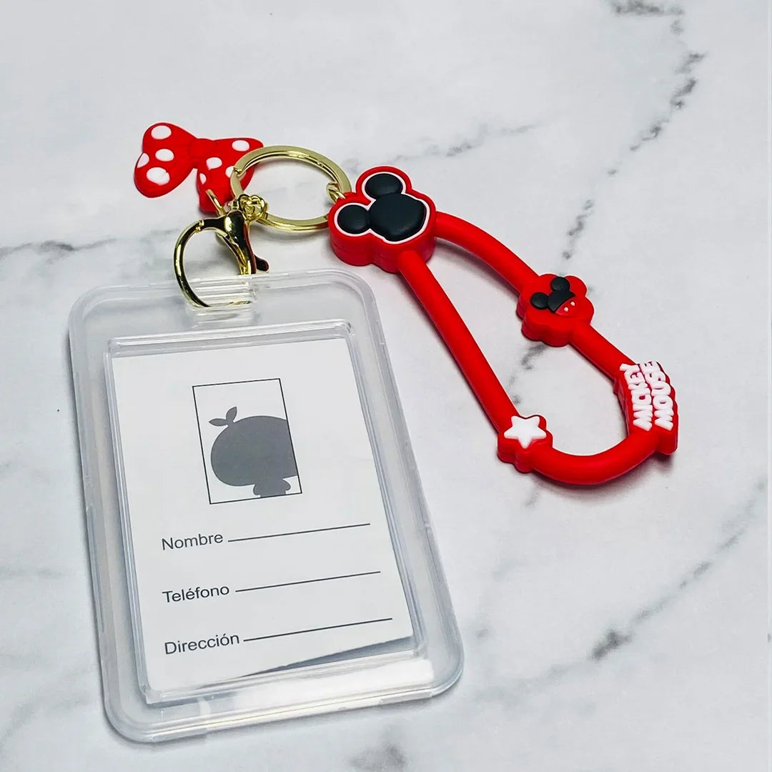 Disney tag key chains with Mickey Mouse design and clear ID holder on marble background
