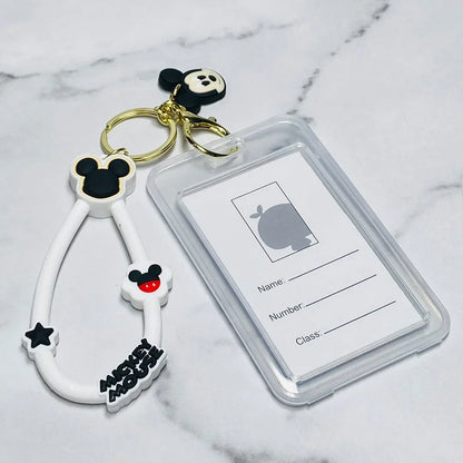 Disney tag key chains with Mickey Mouse design and clear ID holder on a marble background