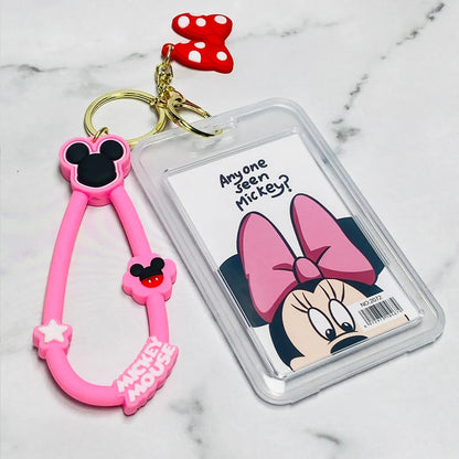 Pink Disney tag key chains featuring Mickey Mouse and a Minnie Mouse themed card holder with red bow charm