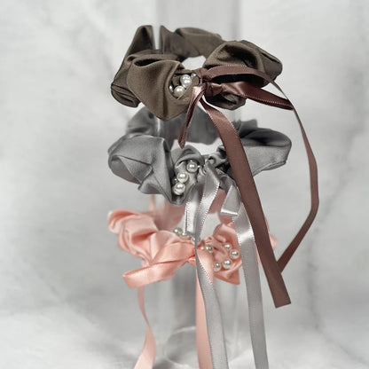 Set of elegant beaded ribbon hair tie in brown, gray, and pink with pearl accents and long ribbons