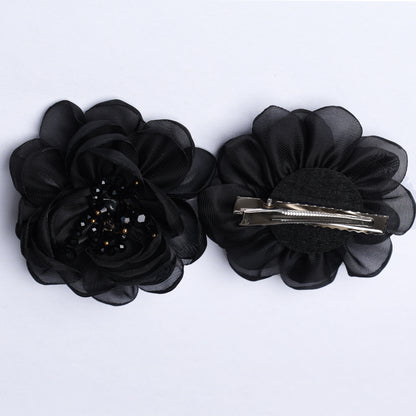 Black floral organza hair pins with layered petals and beaded center detail