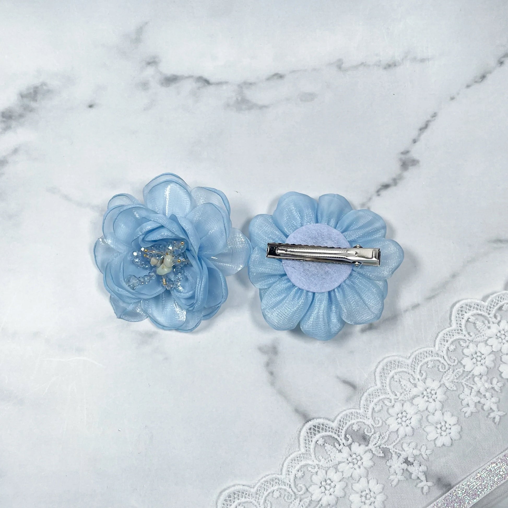 Blue floral organza hair pins with delicate layered petals and metal clip backing