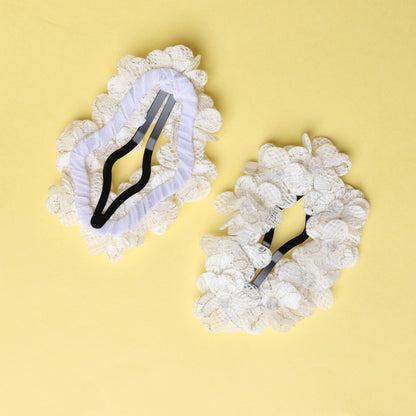 White flower crystal hair pins with lace petals on a yellow background
