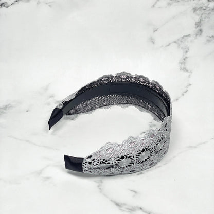 Grey lacy hairband with intricate floral lace design and black inner band for comfortable wear