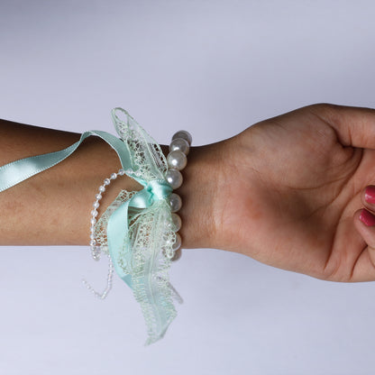 Lace satin pearl hair ties with mint ribbon and pearls worn on wrist by mydevelopmentstor