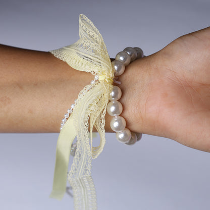 Lace satin pearl hair ties featuring delicate lace and satin ribbon with pearl beads on wrist