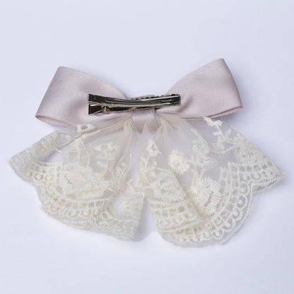 Lacy bow frill alligator clip with beige satin bow and delicate white lace detailing