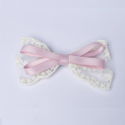 Pink satin and white lace Lacy Bows with Ribbon on a light background