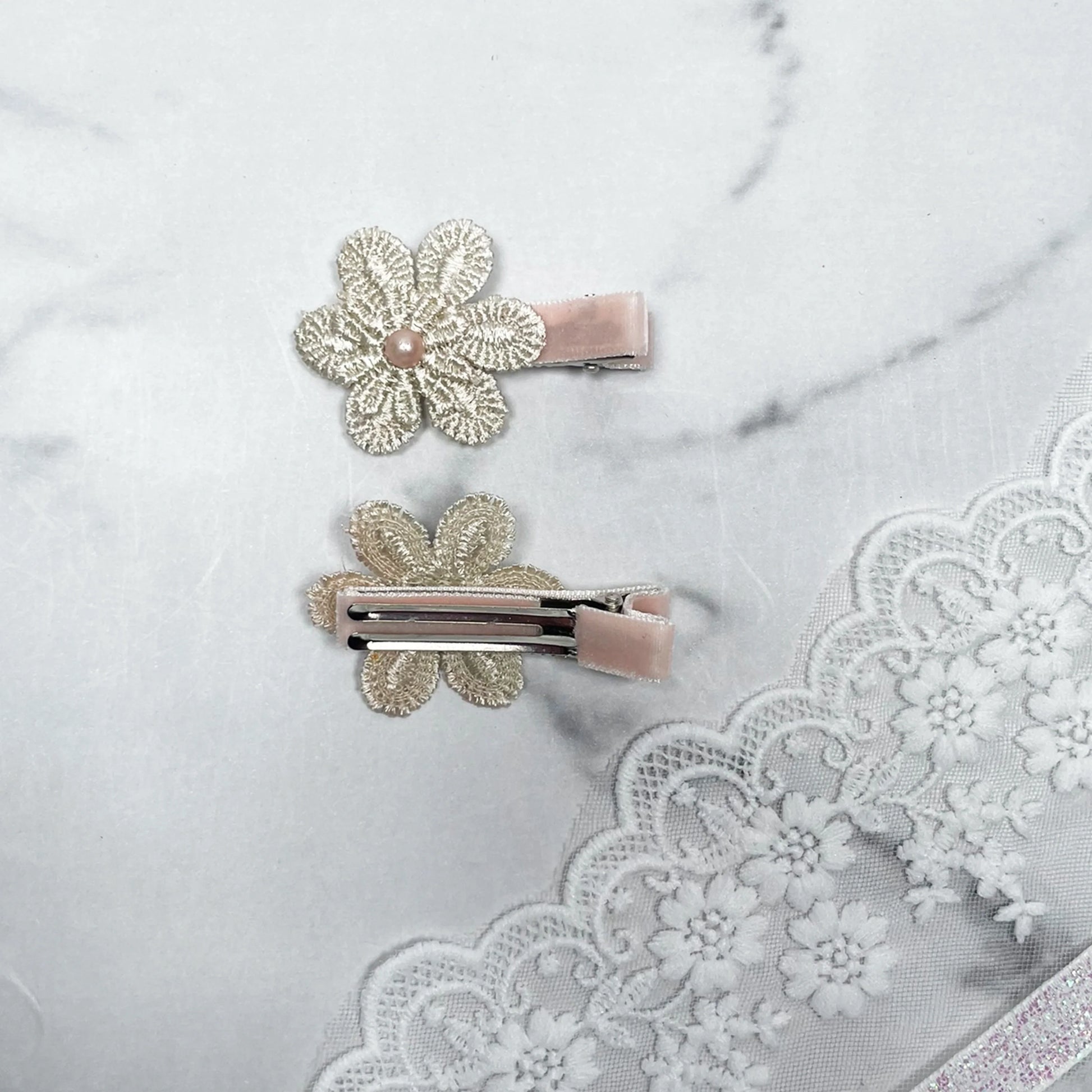 Lacy Flower Alligator Hair Pins with Beads in beige with pink bead embellishments on a marble and lace background