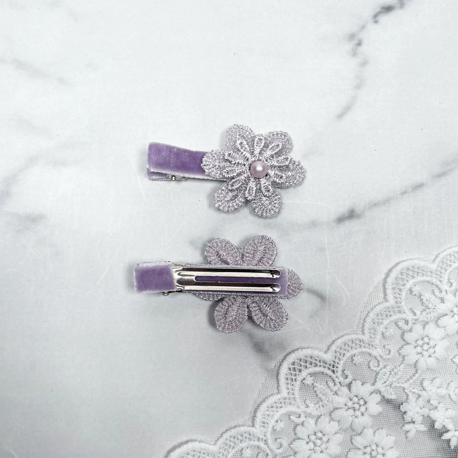 Lacy Flower Alligator Hair Pins with Beads in lavender with delicate lace and pearl details on white background