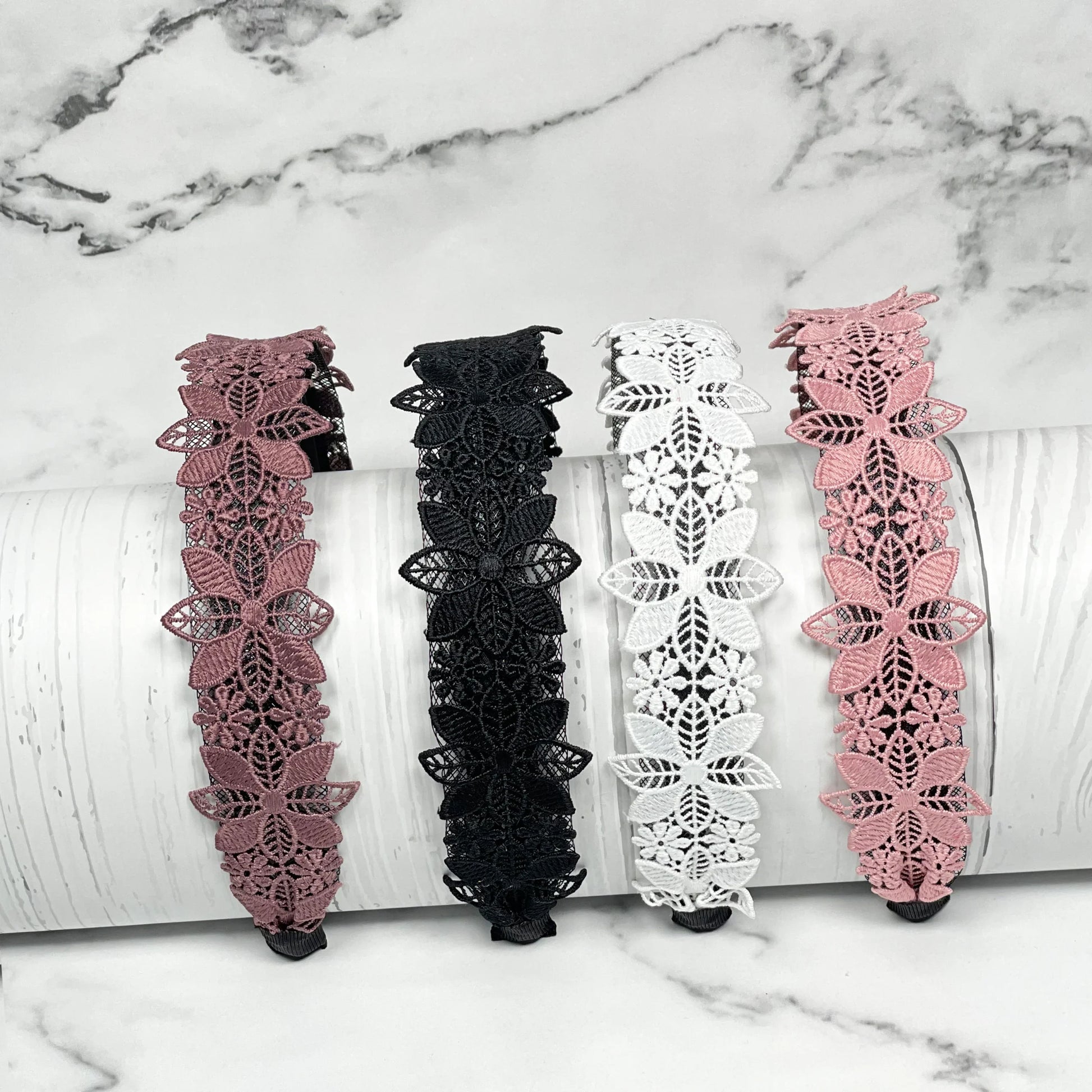 Medium broad colored hair bands in pink, black, white and dusty rose with floral lace design