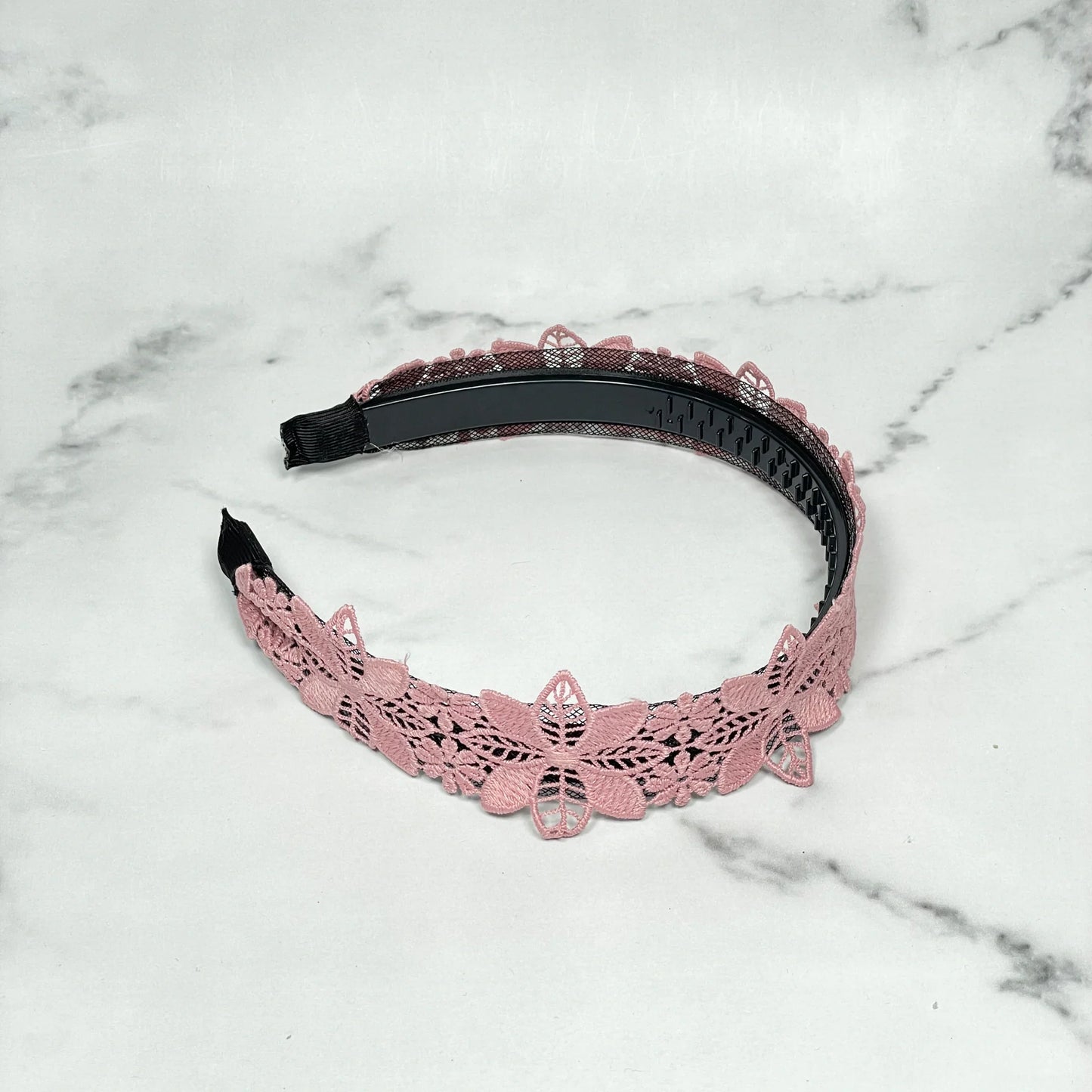 Pink floral lace medium broad colored hair bands on marble surface for stylish hair accessories