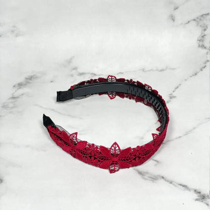 Red lace medium broad colored hair bands with floral design on a white marble background