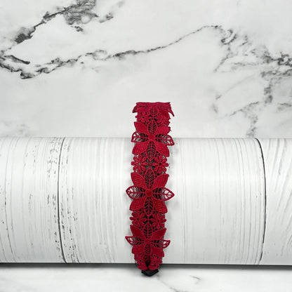 Red medium broad colored hair bands with floral lace design displayed on a white textured background