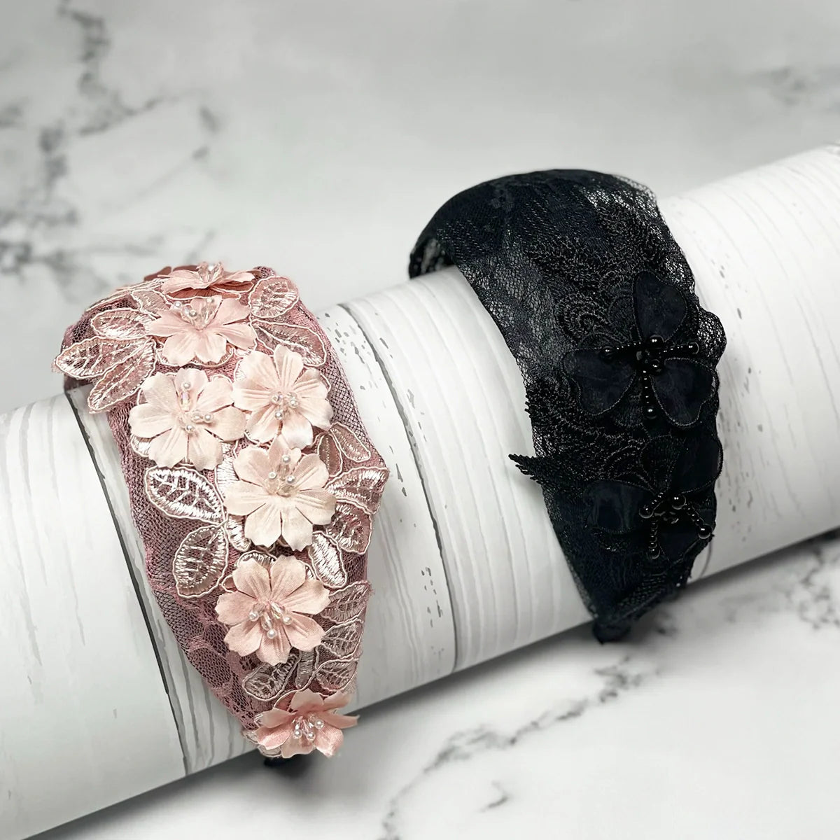 Pink and black mesh broad hairband with floral lace designs on white display