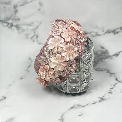 Pink floral mesh broad hairband with delicate lace and flower applique on a marble background