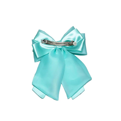 Light blue Organza and Satin Bow Clips with a metal clasp on marble background
