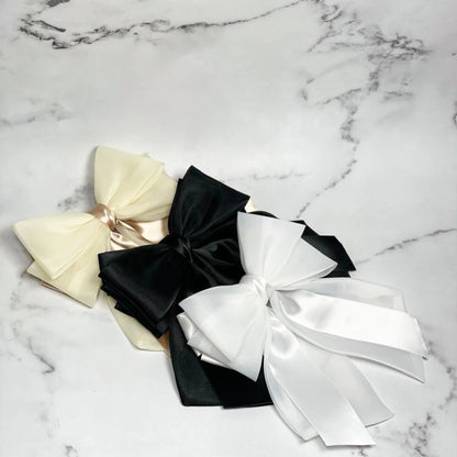Elegant Organza and Satin Bow Clips in cream black and white on marble surface