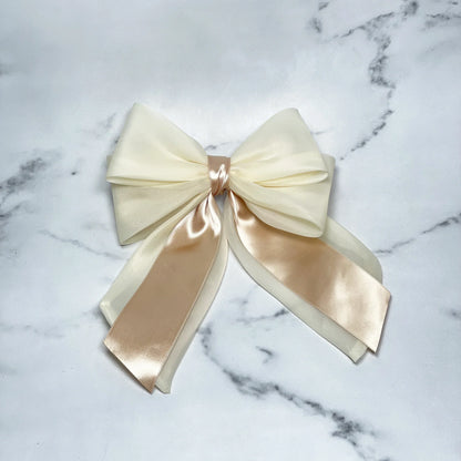 Elegant Organza and Satin Bow Clips in ivory and champagne colors on a marble background