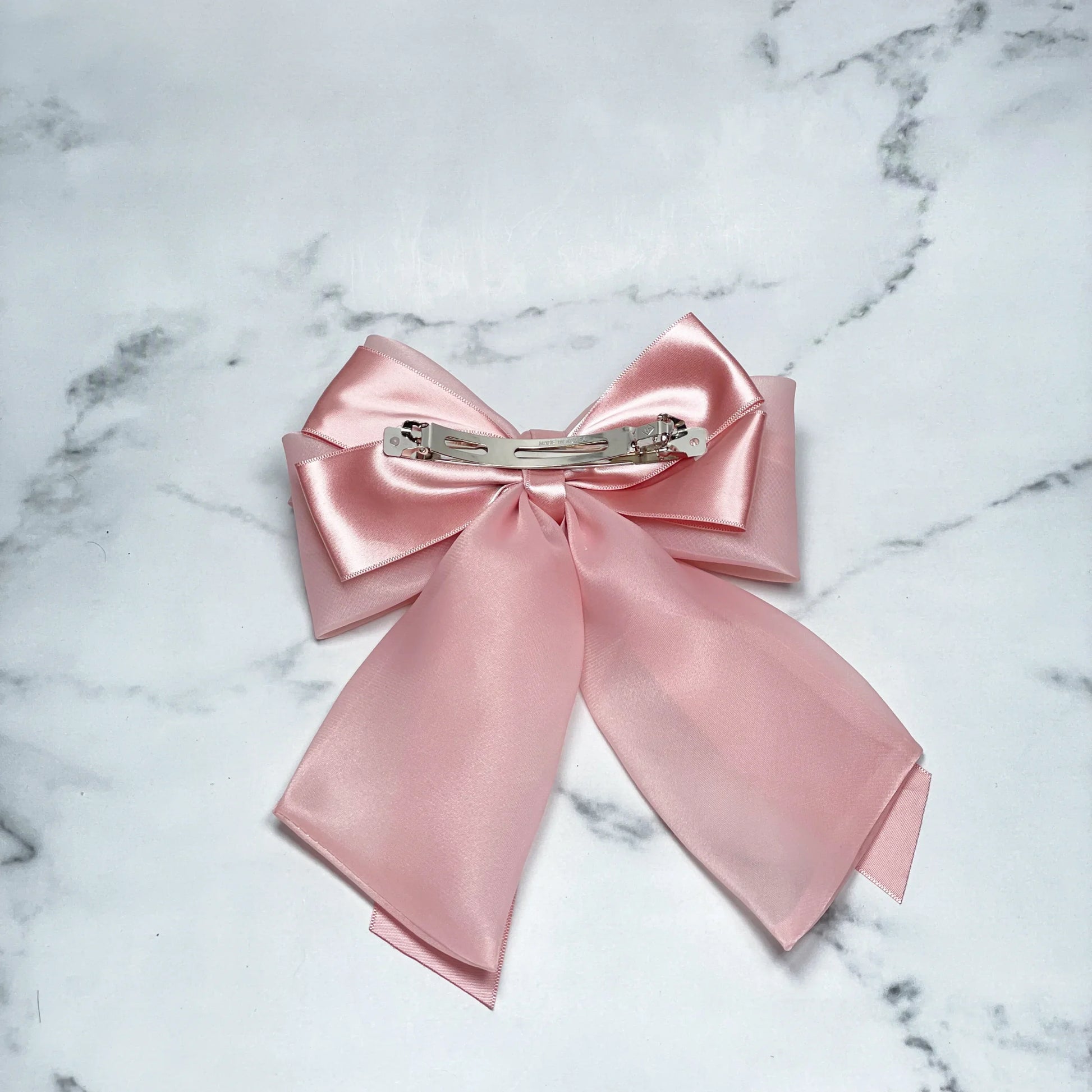 Pink Organza and Satin Bow Clips with metal clip on marble background for hair accessories
