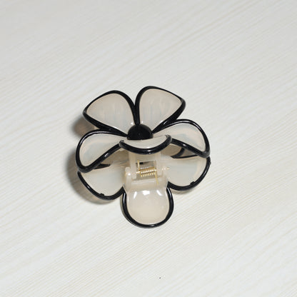 Pearl Finish Single Flower Clutch hair clip with black-edged petals on a light background